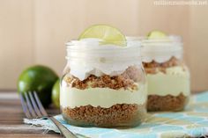 two mason jars filled with dessert sitting on top of a table