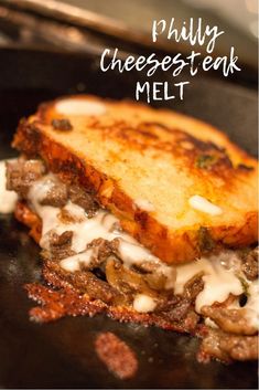 a close up of a sandwich on a pan with cheesesteak in the background