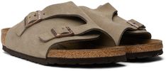 Suede slip-on flat sandals in taupe. · Open toe · Strap and pin-buckle tabs at vamp · Logo embossed at inner side · Logo stamp at molded suede footbed · Cork midsole · Treaded EVA rubber sole · Logo-engraved antiqued bronze-tone hardware Supplier color: Taupe suede Casual Slip-on Footbed Sandals With Suede Lining, Flat Suede Footbed Sandals With Leather Footbed, Flat Suede Sandals With Leather Footbed, Brown Suede Slides With Buckle Closure, Casual Slides With Suede Lining And Round Toe, Casual Beige Slides With Buckle Closure, Casual Footbed Sandals With Suede Lining And Round Toe, Casual Beige Slides With Leather Sole, Birkenstock Taupe