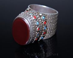 Old Afghan Turkmen Sterling Silver Tribal Ring with rich ornations, little red and turquoise glass beads and an oval carnelian gemstone. This is a mens ring with a big size US 10 1/2. The ring is in a very good condition with a wonderful patina. The silver is of high purity.Size 10 1/2 (the widest part of the ring band is 10.5, the middle part 10)Weight 19 gHere you can find all silver rings in this shop TribalshopSalome:https://www.etsy.com/de/shop/TribalshopSalome?ref=seller-platform-mcnav&amp Traditional Oval Red Ring, Traditional Oval Carnelian Rings, Traditional Red Carnelian Ring, Afghani Jewelry Rings, Tuareg Ring Silver, Collectible Red Carnelian Ring, Turkish Men Rings, Red And Turquoise, Red Band