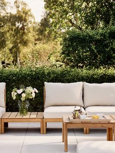 two couches and a coffee table on a patio