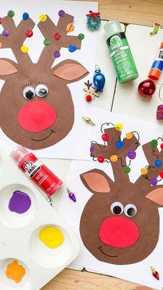 paper plate reindeer craft with paint and glue on the table next to it, surrounded by other arts and crafts supplies