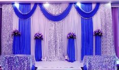 a purple and white wedding setup with flowers