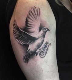 a woman's arm with a bird and the word god on it, in black and white