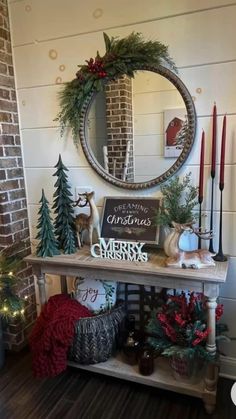 a christmas display with candles, wreaths and other holiday decorations in front of a brick wall