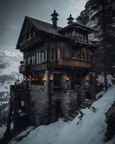 an old wooden house on top of a snowy mountain