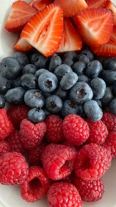 berries and strawberries are arranged on a plate