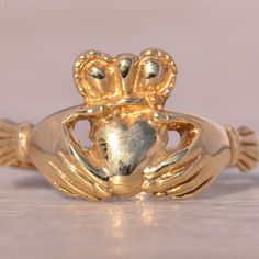 The Limerick: Classic Claddagh Ring In Yellow Gold. This Classic Claddagh Ring Features A Polished Heart At The Center, Topped With A Crown And Flanked By Traditional Hands On Either Side. Crafted In Yellow Gold, The Ring Is Currently A Size 6 But Can Be Resized To Fit Any Finger For An Additional Fee Upon Request. Yellow Gold Color, Claddagh Ring, Claddagh Rings, 6 Rings, The Ring, Gold Yellow, Womens Jewelry Rings, Hands On, Gold Color