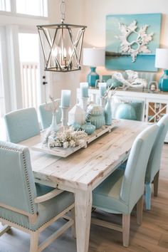 the dining room table is set with blue chairs