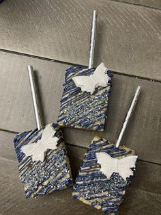 four pieces of blue and white cake sitting on top of a wooden table