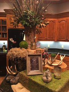 a kitchen counter topped with deer antlers and a framed menu next to a potted plant