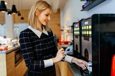 a woman standing in front of a vending machine