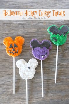 three mickey mouse treats on sticks with the words halloween mickey crispy treats