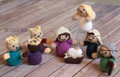 small crocheted figurines sitting on top of a wooden table