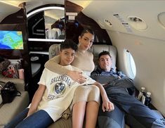 a man and woman sitting on the back of an airplane