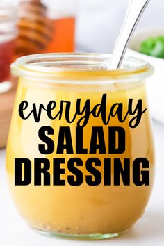 a jar filled with salad dressing sitting on top of a table