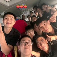 a group of young men sitting in the back of a car with their thumbs up