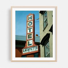 a hotel sign hanging from the side of a building