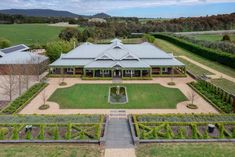 an aerial view of a large house surrounded by greenery