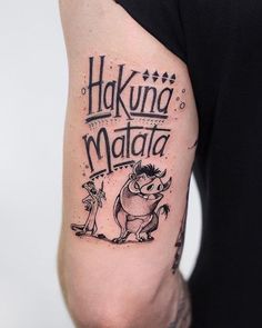 a man with a tattoo on his arm that says hakuna matata