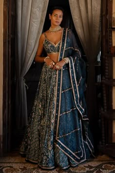 Navy blue lehenga with combination tropical floral-striped prints and embroidered highlights. Comes with a matching padded blouse and a tissue dupatta with antique gold hand embroidery. Components: 3 Pattern: Printed, Embroidered Type Of Work: Floral, Striped Patterns Neckline: Plunged V-Neck Sleeve Type: Sleeveless Fabric: Blouse and lehenga : Organza, Dupatta : Tissue Color: Blue Other Details:  Lehenga: Attached lining Embroidered highlights Closure: Side zip Blouse: Padded Attached lining Cl Navy Blue Lehenga, Tissue Dupatta, Orang India, Indian Fits, Wedding Fits, Indian Outfits Lehenga, Diana Penty, Anamika Khanna