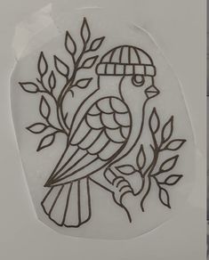 a stencil depicting a bird sitting on a branch with leaves in the background