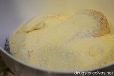 a metal bowl filled with yellow powdered food