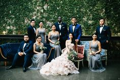 a group of people in formal wear posing for a photo