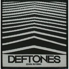 a black and white patch with the words deftones on it's back side