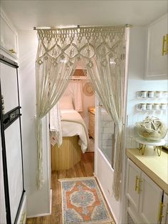 Renovated 1991 RV. White walls, wood floor, porcelain tile shower and kitchen backsplash, wood fluted bed, macrame hanging, linen bedding Hippy Caravan Interior, Girly Rv Interior, Boho Camper Ideas, Camper Interior Ideas Boho, Small Rv Interior Design, Modern Boho Camper Interior, 70s Rv Remodel, Boho Camper Bathroom, Boho Caravan Interior Bohemian