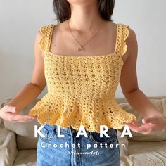 a woman wearing a yellow crochet top with her hands in the air while standing on a couch