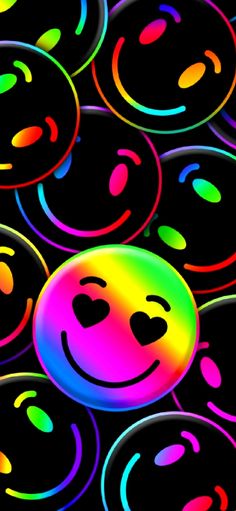 a group of smiley faces painted in different colors on a black background with circles around them