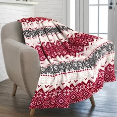 a red and white blanket sitting on top of a chair