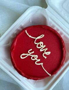 a red cake with the word love on it