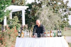 a man sitting at a table with bottles on it