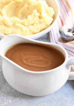 a gravy dish with mashed potatoes in the background