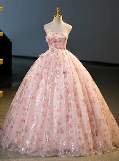 Bursting with vibrant floral motifs and glittering sequins, this Quinceanera dress offers a magical blend of tradition and contemporary style, ideal for your grand celebration. The soft pink base, embellished with exquisite floral patterns, evokes a sense of timeless beauty and grace, while the strapless design with a sweetheart neckline adds a modern, elegant touch. The bodice is adorned with delicate, three-dimensional flowers, providing a captivating focal point that draws the eye. The full, flowing ball gown skirt is designed to dazzle, with its sparkling sequins catching the light and creating a mesmerizing effect with every step you take. This dress is not just an outfit; itan experience, crafted to make you feel like royalty on your special day. Perfect for creating lasting memories Debut Dress, Debut Dresses, Mini Party Dress, Gown Skirt, Black Spaghetti, Sequin Party