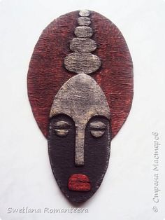 a wooden plaque with a woman's face on it