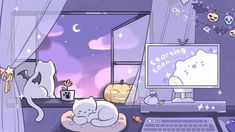 two cats are sleeping on a cat bed in front of a computer screen with halloween decorations