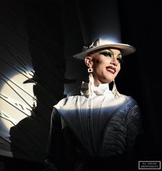 a woman in a white hat and dress