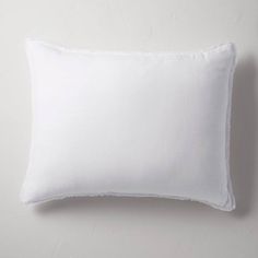 a white pillow on a white wall