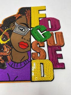 a woman with glasses and the word's name is made out of sequins