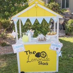 the lemonade shack is set up outside in the grass for an outdoor party or celebration