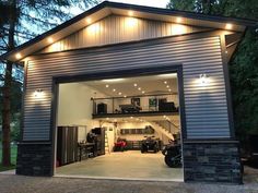 a garage with an open door and lights on it