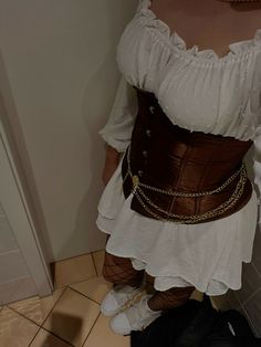 a woman is wearing a corset while standing on the floor in front of a door