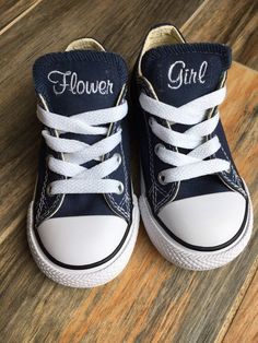 a pair of blue and white shoes with the word flower girl written on them