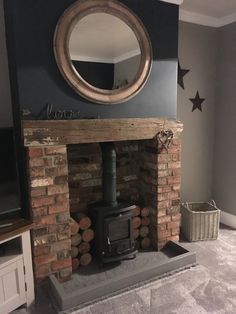 a fire place in a living room with a mirror on the wall and stars above it