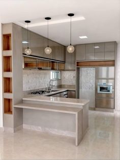 a modern kitchen with stainless steel appliances and cabinets