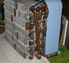 pipes are attached to the back of a large metal box that is stacked on top of each other