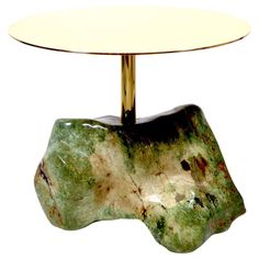 a green and white table with a gold base